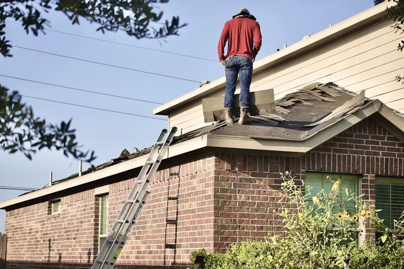 Professional roofer working on a residential roof in Magnolia Trails